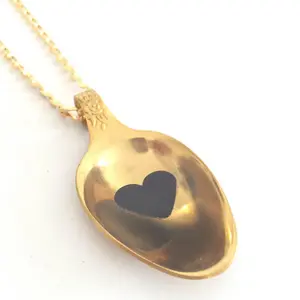 Unique golden teaspoon pendant with a black heart and a resin coat,  vintage style.